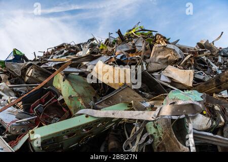 Huge mountain of metal pieces of different origin accumulated in a scrap yard Stock Photo