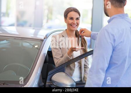 Young couple in the car showroom Stock Photo