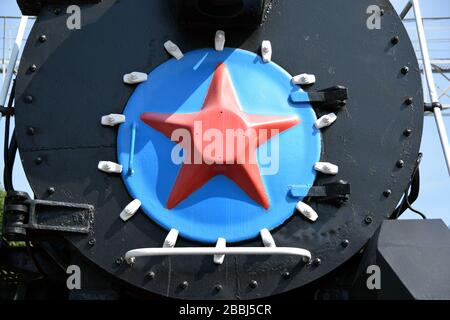 The soviet symbolic red star on the front part of a steam locomotive in the museum of technics in Novossibirsk, Russia. Stock Photo