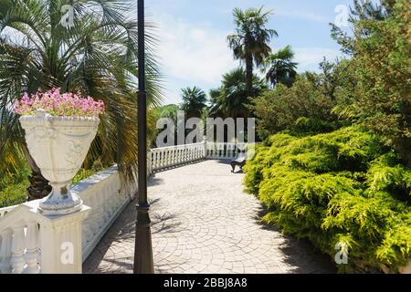 Observation deck with a bench in the old Park. The balustrade is decorated with flowerpots. Yuzhnye Kultury Park Stock Photo