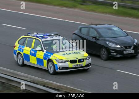 A TAC OPS BMW police car speeding to an emergency on the M6 motorway near Preston in Lancashire Stock Photo