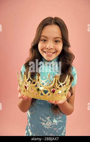 i am so happy. miss japan queen winner. selfish champion kid. happy kid chinese dress wear crown. portrait of pride. japanese kimono. child national costume of japan. small asian girl long curly hair. Stock Photo