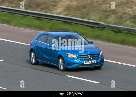 2014 Mercedes-Benz A180 Blue efficiency Se Cdi Blue car driving on the M6 motorway near Preston in Lancashire, UK Stock Photo