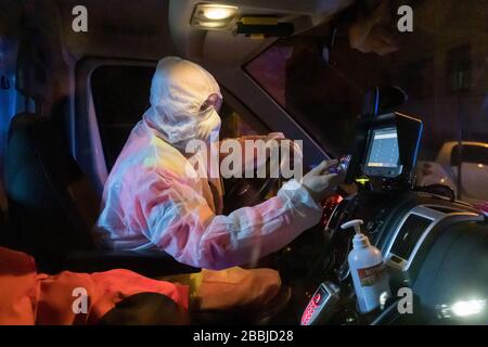 Ferrara, Italy. 31 March, 2020.  A nurse drives an ambulance wearing safety suit, gloves, glasses and sanitary mask due to the coronavirus covid-19 emergency in Ferrara, Italy.   Credit: Filippo Rubin / Alamy Live News Stock Photo