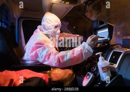 Ferrara, Italy. 31 March, 2020.  A nurse drives an ambulance wearing safety suit, gloves, glasses and sanitary mask due to the coronavirus covid-19 emergency in Ferrara, Italy.   Credit: Filippo Rubin / Alamy Live News Stock Photo