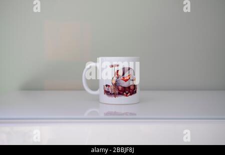 super dad cup and its reflection. There is a Super dad and sleeping baby girl figures on the cup Stock Photo
