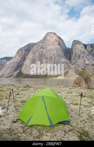 Tent pitched at rock climbers camp below stunning granite mountains. Stock Photo