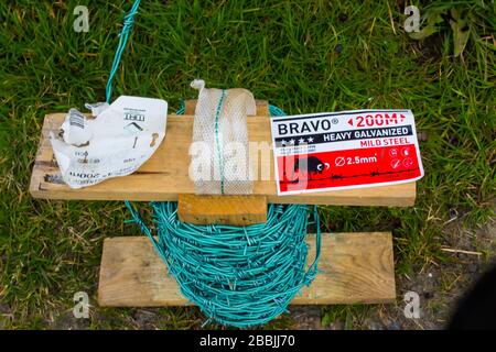 Barbed wire used as security perimeter fencing for the control of livestock in a farm setting. Stock Photo