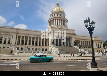 Classic auto drives past the Capitolio building, Havana, Cuba Stock Photo