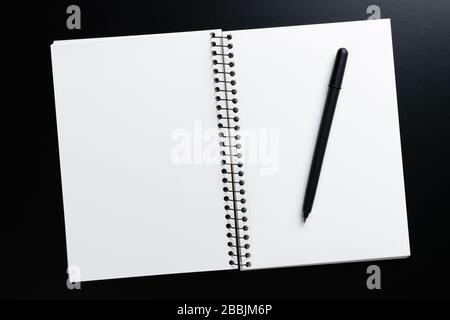Black style set: notepad and pen on Black background. Stock Photo