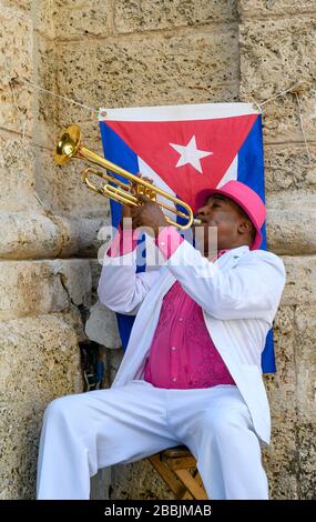 Trumpet player in Havana, Vieja with flag,  Cuba Stock Photo