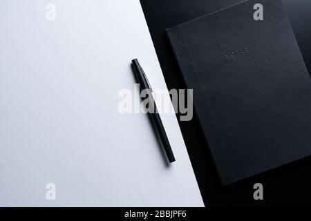 Black style set: notepad and pen on Black background. Stock Photo