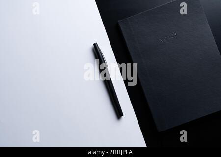 Black style set: notepad and pen on Black background. Stock Photo