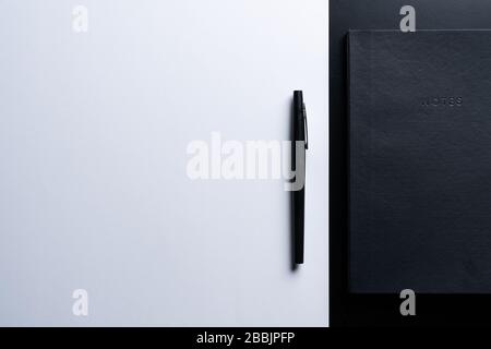 Black style set: notepad and pen on Black background. Stock Photo