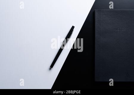 Black style set: notepad and pen on Black background. Stock Photo