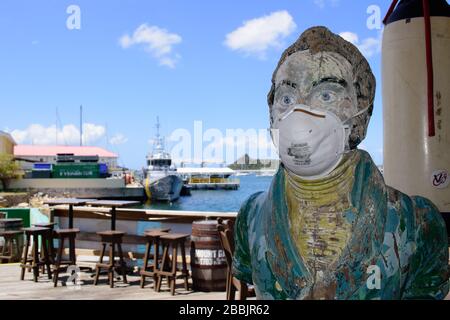 The bar mascot at the Sint Maarten Yacht Club Bar & Restaurant wears a (used) face mask while it is closed for the Covid-19 Pandemic in late March '20 Stock Photo