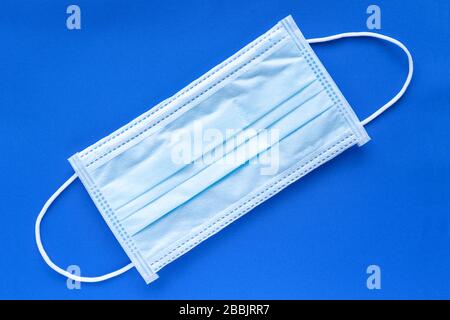 Typical 3 ply surgical face mask with rubber ear straps. Stock Photo