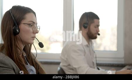 Young woman having business call in office Stock Photo