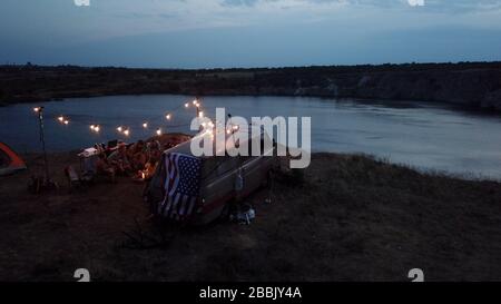 Friends Having Rest in Campsite Having Drinks Stock Photo
