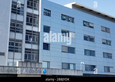 Healthcare workers dealing with the new coronavirus crisis look through the windows of the Hospital in Coruna, northwestern Spain, on March 26,2020 Stock Photo