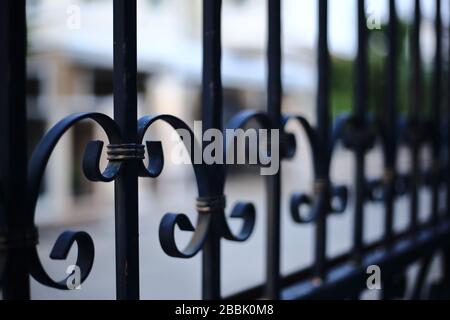 lock down, stay at home and business closed concepts. close up image of fence made of iron cast metal rods. Stock Photo