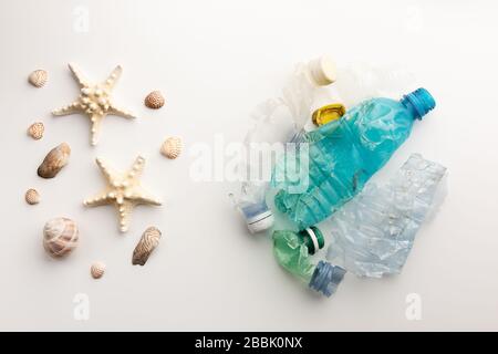 large garbage pile isolated on white background with seashells, global warming Stock Photo