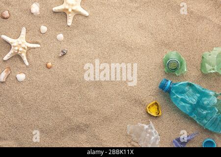 A Lot of rubbish washed up on the beach near seashells Stock Photo