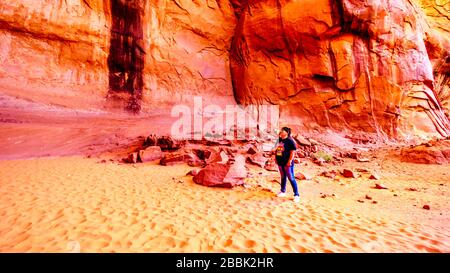 Navajo woman singing a traditional song in the Big Hogan cave to demonstrate the acoustics in the sandstone formation in Monument Valley Stock Photo