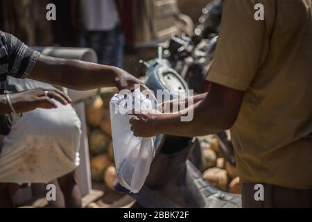 Selling vegetables on plastic cover. Street life of Indian people in market.Large Sunday market.Selling and buying local vegetables, and food from str Stock Photo