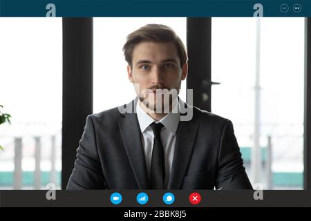 Headshot portrait screen application view of young businessman talk on video call with business client online, millennial male employee worker engaged Stock Photo