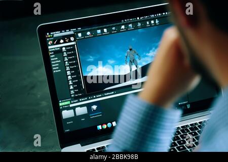 Bishkek, Kyrgyzstan - March 14, 2019: developing a video game on unreal engine on a laptop with a team member as a developer, designer, or tester Stock Photo