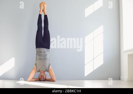 Sportive man doing yoga exercise in studio Stock Photo