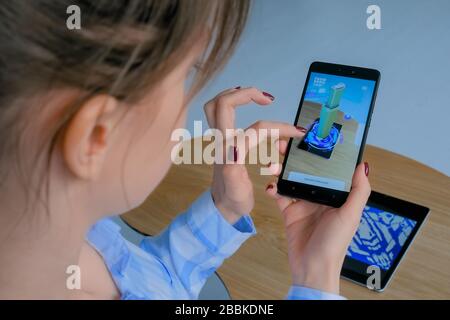 Woman using smartphone with augmented reality app Stock Photo