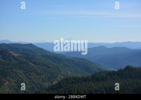 View along a valley and across multiple mountain ridgelines from Windy Ridge in Mt St Helens in Washington State to Mt Hood in Oregon, USA. Stock Photo