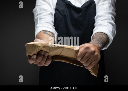 Man hand grab and twist Crate paper for recycle. Eco system. Stock Photo