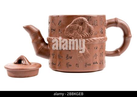 Japanese characters on a teapot translated into English mean "health", "longevity", "wisdom". Traditional Japanese clay teapot for making tea with dri Stock Photo
