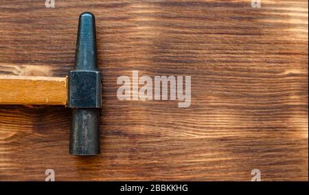 Old repair tool hammer on brown color wooden background. Labor day concept Stock Photo