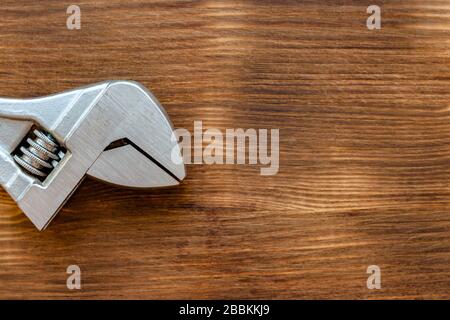 Labor fathers day concept. Repair tool spanner on brown color wooden background. Stock Photo