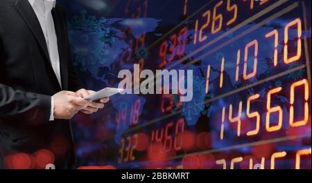 Economic crisis, Businessman using tablet analyzing sales data and economic graph chart that is falling due to the corona virus crisis, Covid-19, stoc Stock Photo
