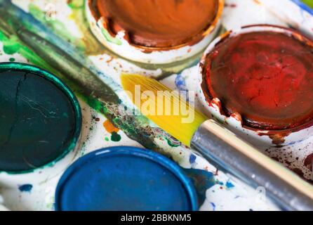 Back to school concept, colorful watercolor paintbox, paints and brush, close-up Stock Photo