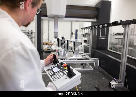 Quality engineer measuring some moldings by professional 3D measuring system machine, industrial concept Stock Photo