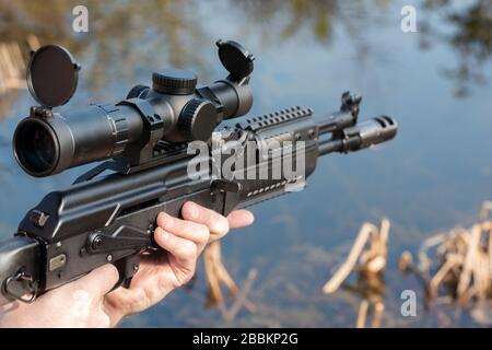 A man is holding a rifle Stock Photo