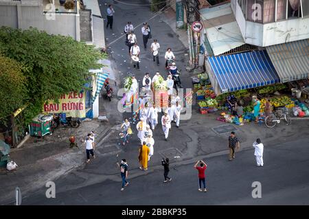 Pham Van Dong Street, Go Vap District, Ho Chi Minh City, Vietnam - February 15, 2020: A funeral is held in the traditional way on the street at Pham V Stock Photo