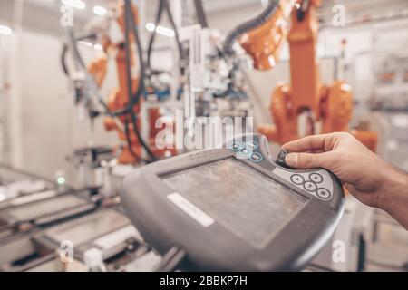 Engineer, technician working with automatic robot in automotive industrial, smart factory, automated workplace Stock Photo