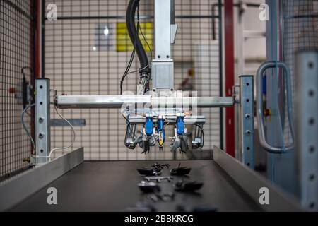 Automatic machine for getting the plastic moldings from injection molding machine, automotive and industrial concept Stock Photo