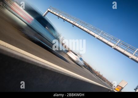 Car passing through a toll gate on a highway, highway charges, motion blurred image Stock Photo