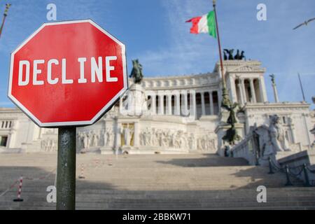 Decline sign with Altar of the Fatherland in Rome, Italy. Threat of financial crash in Italy because of coronavirus. Global economic crisis Stock Photo