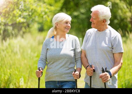 Senior Couple Exercising In Park Stock Photo