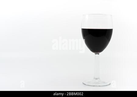 Glass of red wine on a plain white background with space for copy Stock Photo