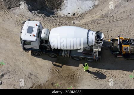 Wien, Vienna: work at construction site starts again after corona virus stop, ready-mix truck, truck mixer, worker, construction site 'Danube Flats', Stock Photo